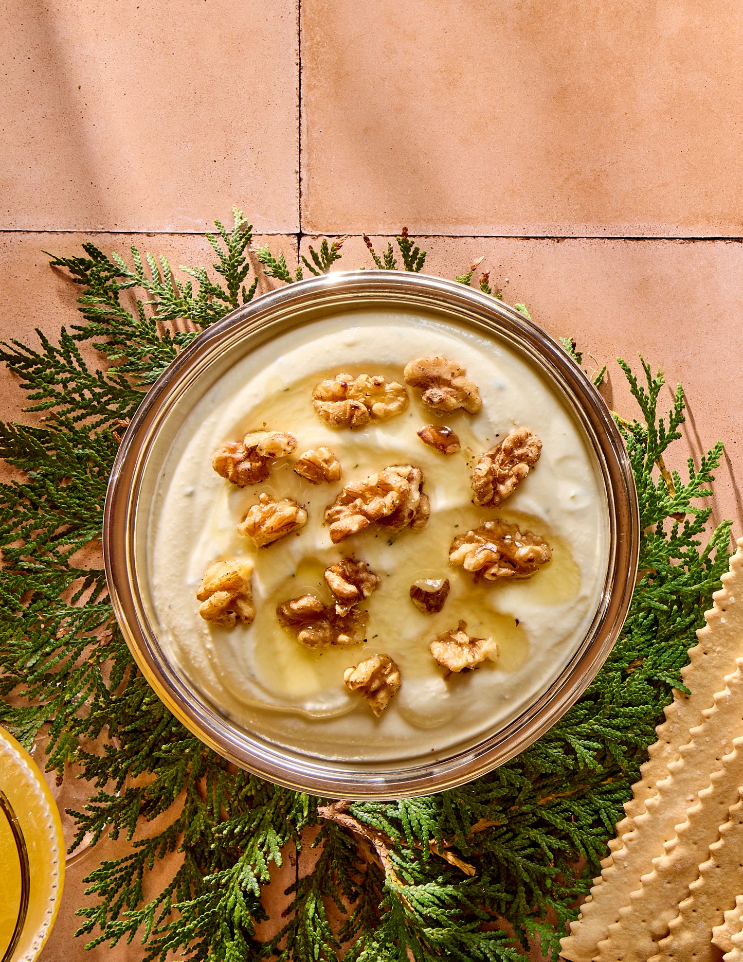 Bowl with whipped ricotta with walnuts and honey on top.