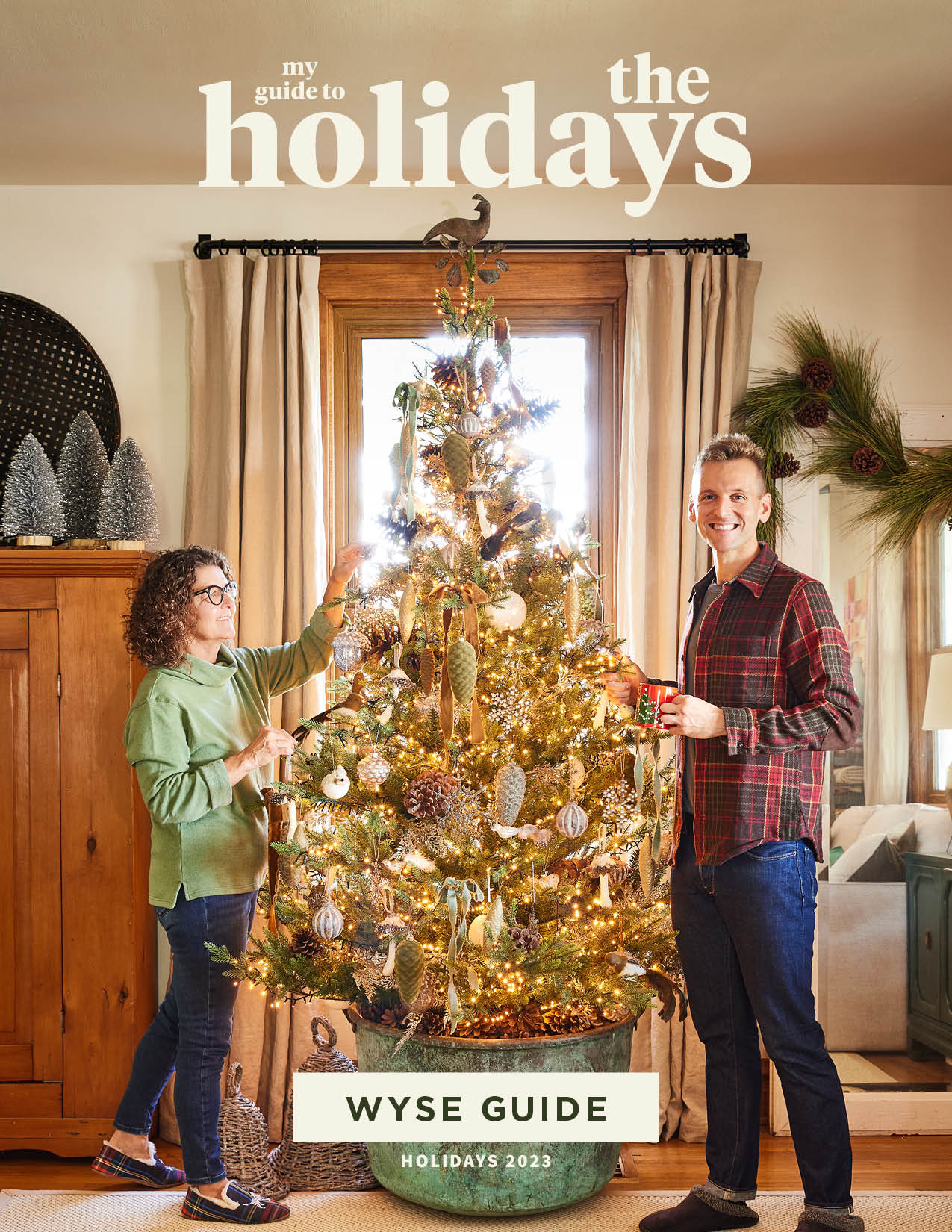 Kaleb Wyse wearing plaid shirt standing beside Christmas tree with mom Jodi to the side.