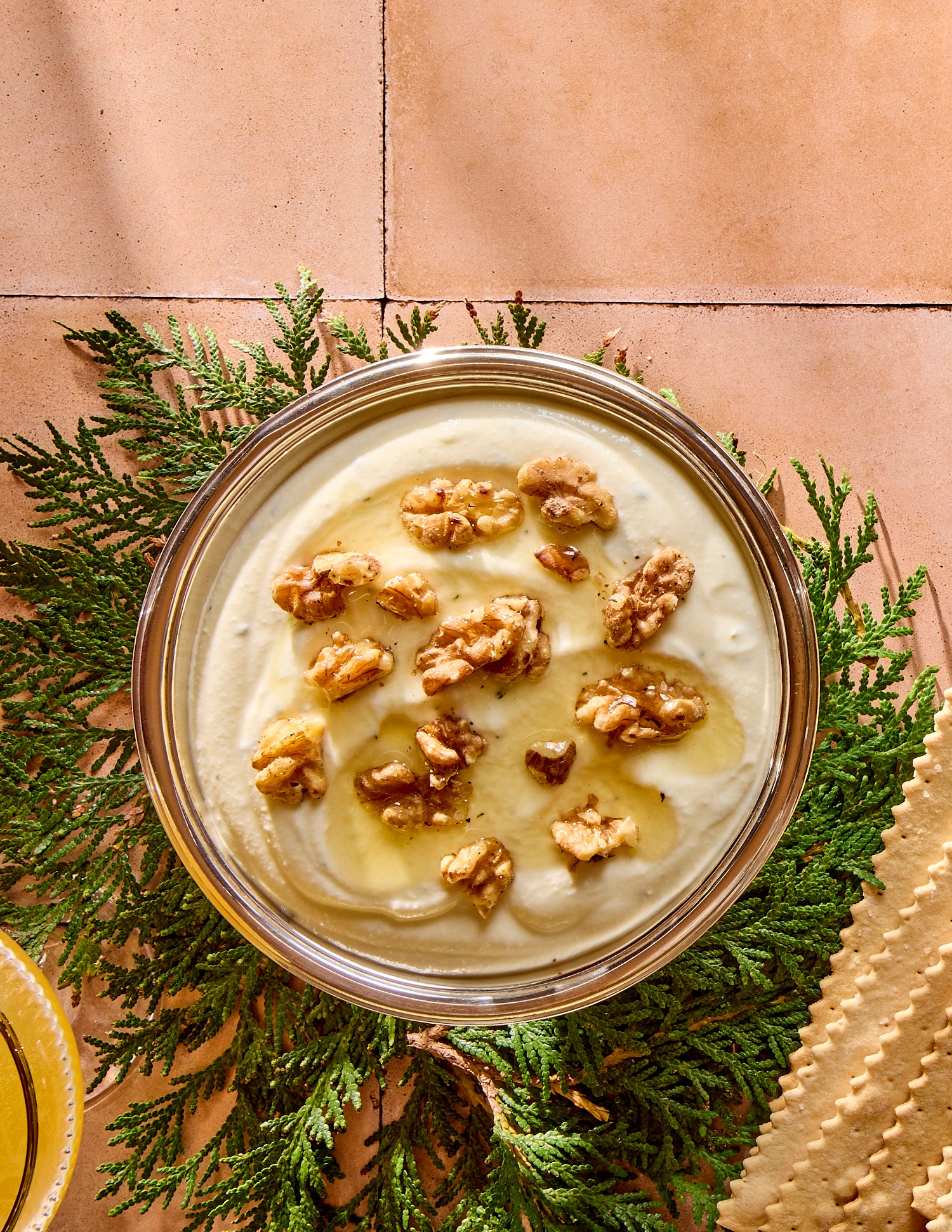 Bowl with whipped ricotta with walnuts and honey on top.