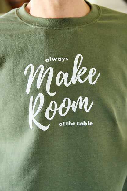 Green sweatshirt with the words "Always Make Room at the Table".