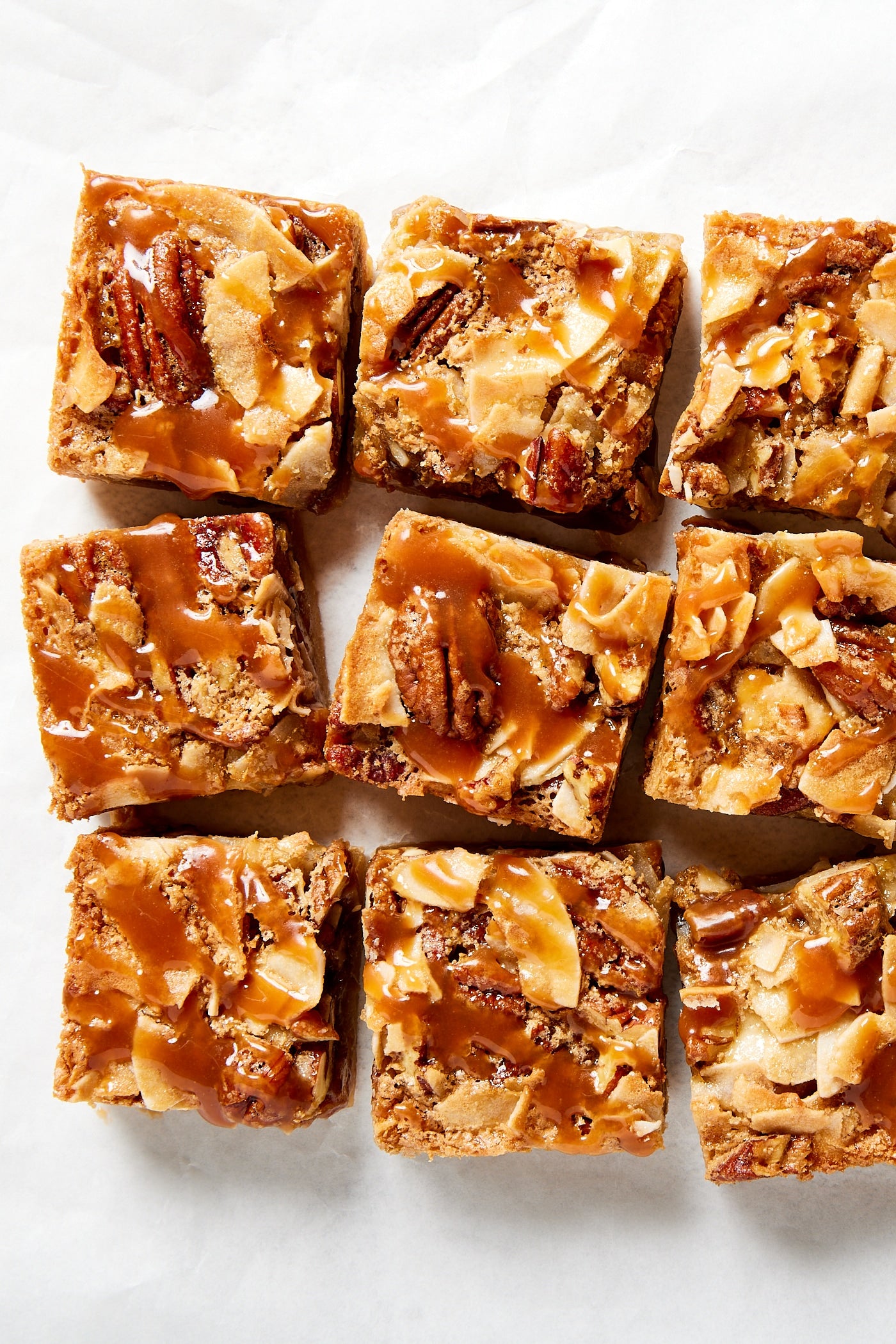 Caramel poured over the top of bars on piece of parchment.