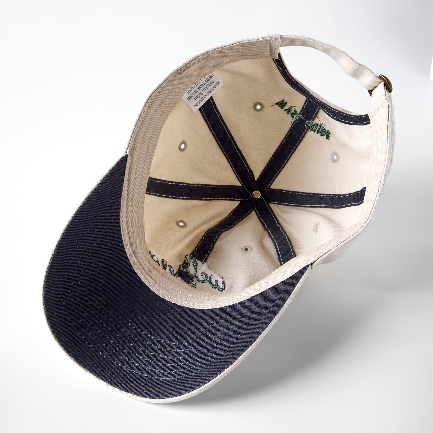 Underside of a ball cap showing navy brim.