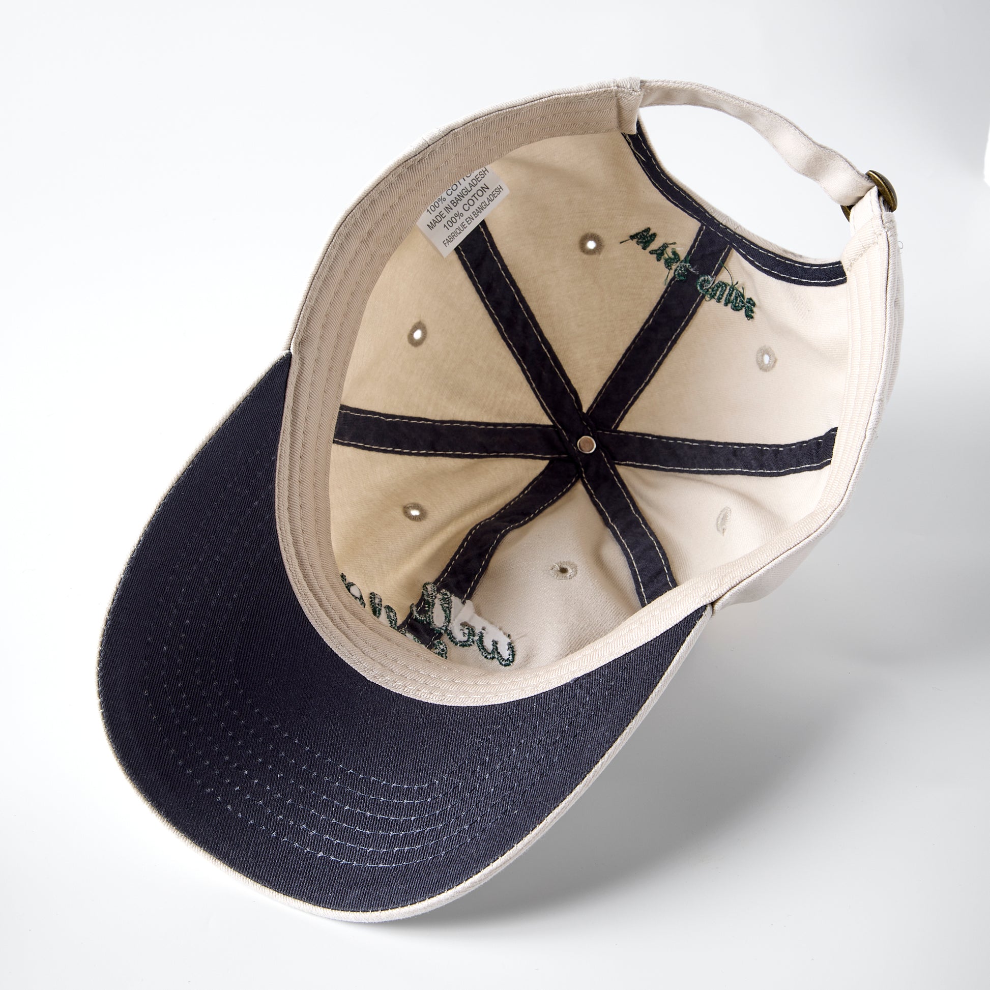 Underside of a ball cap showing navy brim.